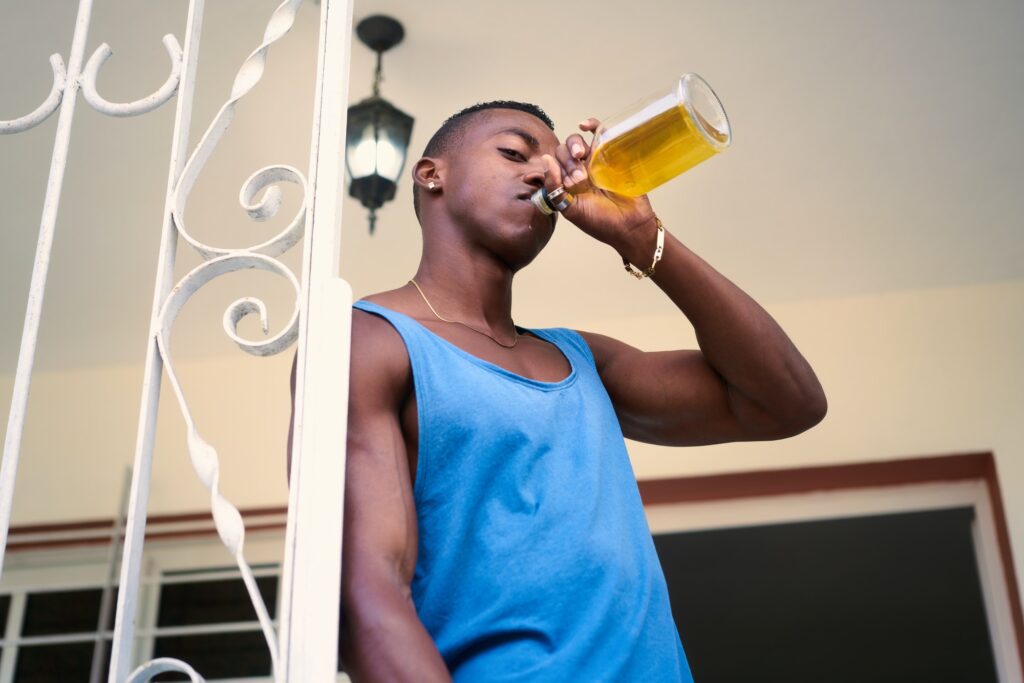 Lonely Unemployed Black Man Drinking Alcohol At Home